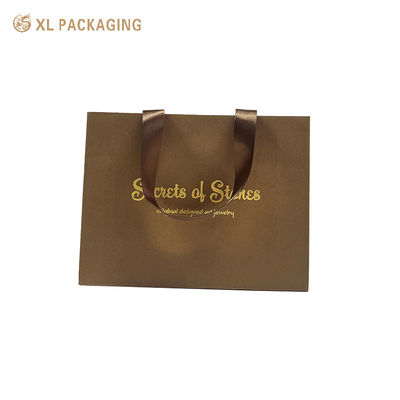 Buy Luxury Paper Gift Bag with Gold Foil Hot Stamping, Wide Satin Ribbon Handles, and Triangular Foldable Bottom online manufacture