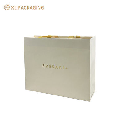 Buy Premium Custom Gold Foil Stamped Paper Gift Bag with Satin Ribbon Handles and Reinforced Folded Top online manufacture