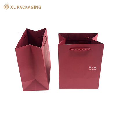 Luxury Wine Red Paper Gift Bag with Custom Logo, Reinforced Folded Bottom, and Twisted Paper Handles for Premium Shopping and Gift Packaging