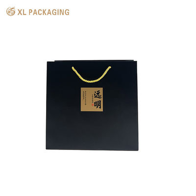Custom Logo Matte Black Paper Tote Bag with Kraft Calligraphy Stickers and Twisted Golden Cord Handles for Eco-Friendly Gift Packaging